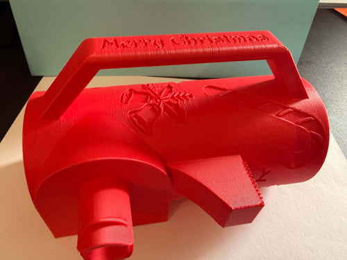 3D printed red Christmas wrapping paper holder with built-in cutter and tape dispenser, embossed Merry Christmas handle