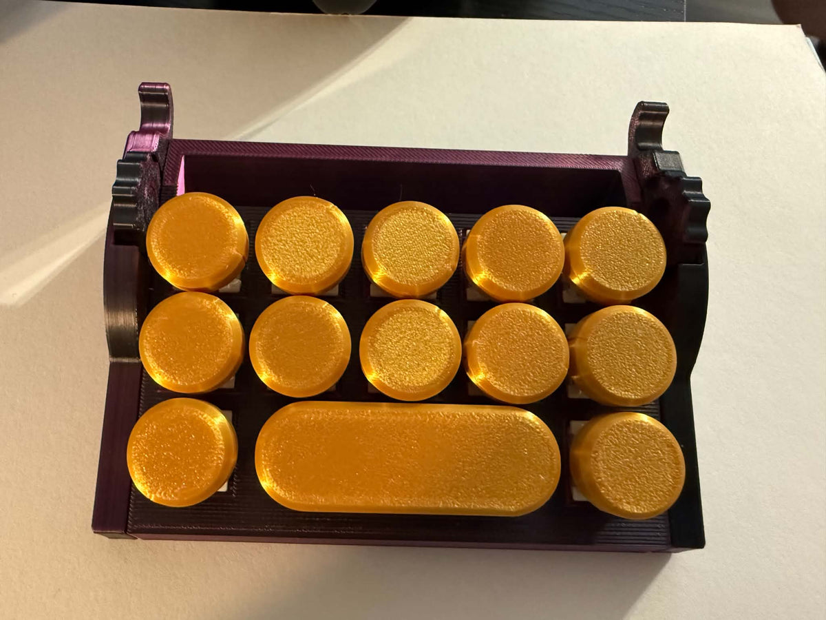 Fidget keyboard clicker and desk organizer in gold and dark purple 3D printed