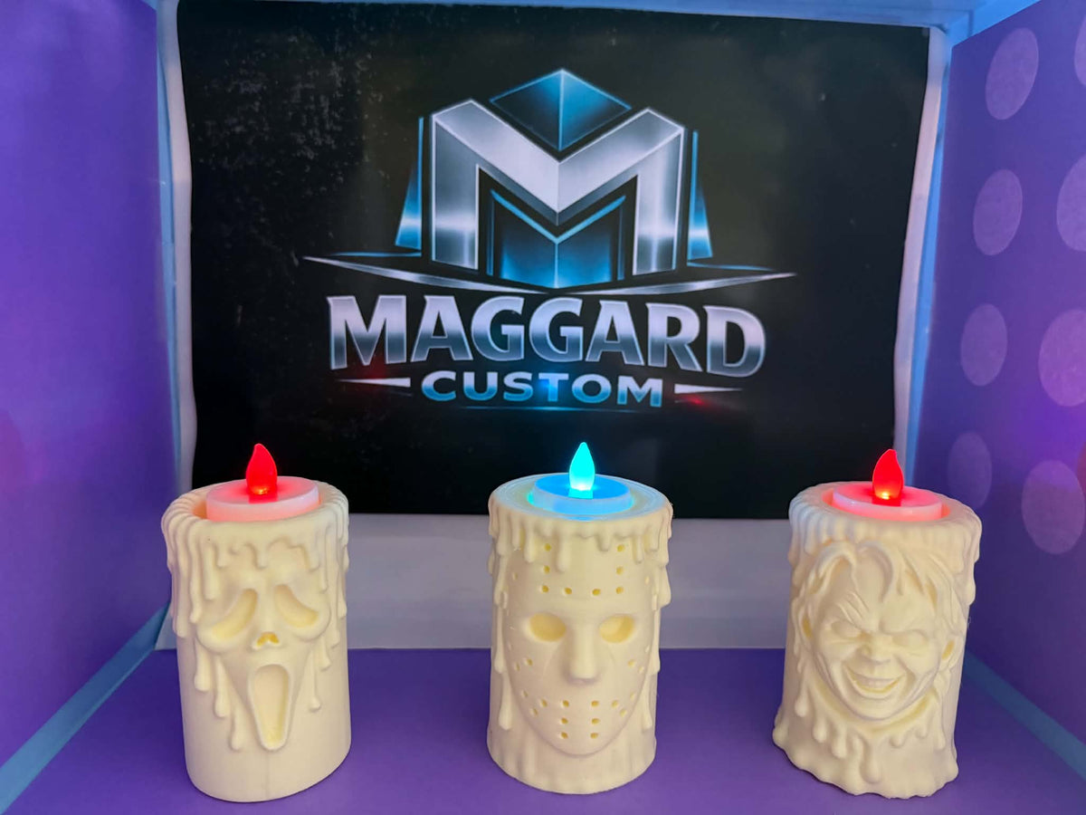 Set of 3 horror-themed 3D printed LED candles with dripping wax designs including mask and doll face styles with glowing LED flames