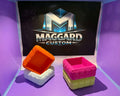 Set of 4 quilted 3D printed square trays in orange and pink color combinations displayed in front of Maggard Custom logo