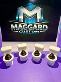 3D printed white toilet bowl fidget clickers with brown surprise inside displayed in front of Maggard Custom logo